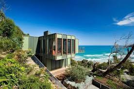 Dogs on edge of sea cliff. Tree Shaped House With Modern Interiors At The Seaside Digsdigs