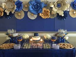 Royal Blue And Gold Dessert Table With Paper Flowers And Fan As Backdrop Blue Graduation Party Gold Party Decorations Gold Graduation Party