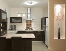 The dark, moody tile walls, sleek backsplash, and stainless steel appliances assert an undeniably glam aesthetic while the wood and brass tones ground the space and give it that classic classic califorina warmth. Small G Shaped Kitchen Designs Home Design And Decor Reviews