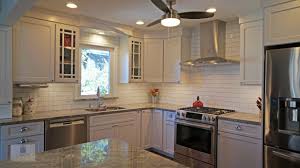 The White Koch Kitchen Cabinets Accented By A Dark Wood Finish Island And Richelieu Hardware Offer Transitional Kitchen Design Kitchen Design Kitchen Cabinets