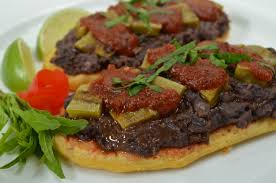 Huarache (sometimes spelled guarache) wa'ɾatʃe is a popular mexican dish consisting of an oblong, fried masa base, with a variety of toppings including green or red salsa, onions, potato, cilantro and any manner of protein such as ground beef or tongue, and then finished with queso fresco cheese. Huaraches Bread And Tortillas