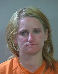 Woman accused of stabbing man, burglary; held