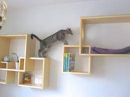 This wave design shelf is shaped to offer a cozy fit with the agile body of cats. Use Your Wall Space Cat Wall Shelves Modern Cat Tree Cat Tree Designs