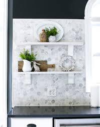 The oven is by wolf, the floor is lined with corten steel tiles and the staircase is suspended from cable supports. Black White Kitchen Bower Power