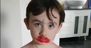 this little boy plays with makeup