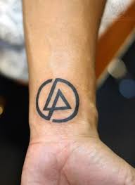 We may earn a co. Linking Park Logo Tattoo In Black Done On A The Inner Side Of A Man S Wrist The Letters L A Wrist Tattoos For Guys Cool Tattoos For Guys Small Tattoos For Guys