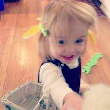 Handing me a hat to wear.