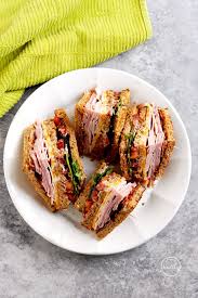 Toast the bread and place one slice on a cutting board or large plate, spread mayonnaise on the side that is face up. Club Sandwich Turkey Ham Bacon A Pinch Of Healthy