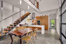 Polished concrete floors offer a sleek alternative to traditional hardwood floors, while an extra wing of the house is the perfect space for the family's teens to relax and hang out. Concrete Floors Both A Statement And A Functional Choice For Modern Homes