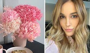 A bouquet of natural tone dried flowers and foliage presented in a ceramic pot. Bec Judd Shows Off Preserved Floral Arrangements In Her Home