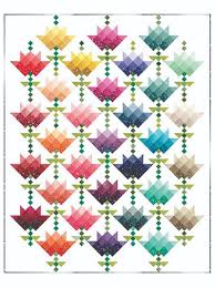 Using 7 half square triangle paper triangles on a roll #h700 makes this shortcut quilt sew together quickly and accurately. Ombre Flower Bouquet Quilt Pattern