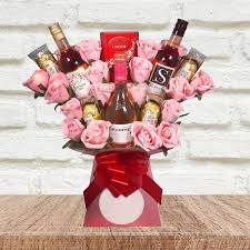 When you want to give something that lasts longer than flowers, surprise someone with a gift hamper picked out just for them! Rose Wine And Pink Roses Chocolate Bouquet Funky Hampers