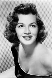 Angie Dickinson, retired actress, early 1960s. She had "... her  breakthrough role in Gun the Man Down (1956) with James Arness and the  Western film Rio Bravo (1959) with John Wayne and