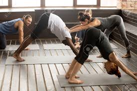 If you have been trying to lose weight by following the diet fads, chances are good that you have achieved no visible results! Yoga Fitness Instructor Teacher Helping African Man Beginner Doing Stretching Downward Facing Dog Exercise Standing In Adho Mukha Svanasana Pose At Studio Group Training Class With Multiracial People Stock Photo Picture And