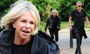 Leslie Ash, 62, uses a walking stick while out for a stroll with her  husband Lee Chapman, 62