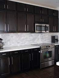 3100 jet black caesarstone quartz is a stunning consistent black quartz that will look fantastic paired with light cabinetry. 63709ca678611471e60975a9952a7eae Jpg 736 981 Pixels Trendy Kitchen Backsplash Kitchen Backsplash Designs Dark Brown Kitchen Cabinets
