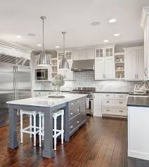 I love the gray island that contrasts the surrounding white cabinets, which stand out against the dark wood floor and honed granite countertops. 49 How To Choose Grey Island White Cabinets Kitchen Decorinspira Com