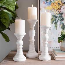 You pop your candle inside the holder, and you're done. White Distressed Candle Holders Set Of 3 Kirklands