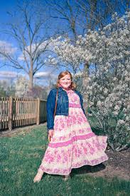 Spell And The Gypsy Collective Coco Lei Strappy Gown A Plus Size Boho Spring Outfit Featuring A Tiered Floral Maxi Dress Denim Jacket And Straw Bag