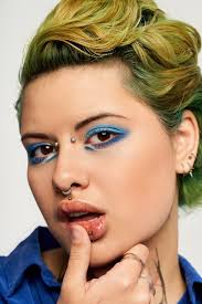 Vibrant Young Woman Showcasing Striking Fashion Stock Photo