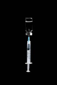 Noise and art punk / alien punk music made by arsene survie Syringe In Covid 19 Vaccine Vial On Black Background Stockphoto