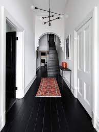 Hallway Decorating Ideas Sophisticated Monochrome Hallway With Statement Light And Boho Rug Nonagon Style Black Wood Floors Hallway Decorating House Design