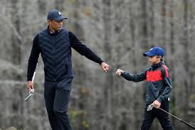 Tiger woods, right, watches as his son charlie tees off on the second hole during the first round of the pnc championship golf tournament, saturday, dec. Watching Tiger Woods Play An Often Hidden Role Dad The New York Times