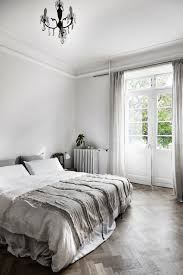 Gray primary bedroom with a modern bed and a desk on the side. Pin On Bedroom Decor Minimalist