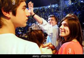 Chile's Presidential candidate Joaquin Lavin of the right-wing opposition  party Union Democrata Independiente (UDI), center, waves to supporters as  he is surrounded by his children Juan Pablo, Maria Jesus and Paulina during