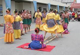The dance involves two people against each other, beating sliding and topping bamboo poles on the ground in coordination with one or two sets of dancers who step over and in between the poles. Tinikling Wikipedia