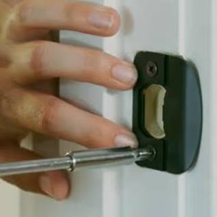 Adjusting the strike plate allows the door latch to click securely into place, AI generated