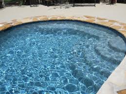 Caribbean blue pool finish brings home the beauty of the caribbean sea to create a glistening backyard landscape. Wet Edge Products Blue Lagoon