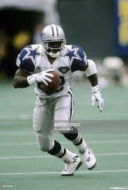 Emmitt Smith Of The Dallas Cowboys Carries The Ball Against The New Dallas Cowboys Cheerleaders Dallas Cowboys Football Wallpapers Dallas Cowboys Football Team