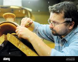 In this May 13, 2010 picture, Radovan Krkos, a saddle maker from Slovakia,  carves a design