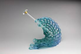 Decorative plates, a nice cutlery set, and the past summer's greatest hits in a vase. Carol Milne Knitted Glass Sculpture With Knitting Needles