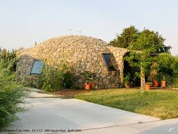 A Rock Covered Dome Monolithic Dome Homes Dome House Geodesic Dome Homes