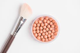 bronzing pearls with makeup brush on