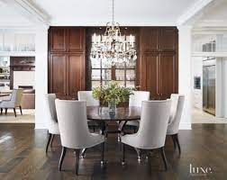 Inspired by ancient astronomy armillary spheres, the interlocking rings pivot for an infinite variety of positions. Transitional White Dining Room With Crystal Chandelier White Dining Room Family Room Design Interior
