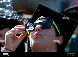 Graduating Arts and Sciences senior Erin Forman of Boca Raton, Florida,  passes the time before commencement ceremonies to blow bubbles at  Washington University in St. Louis