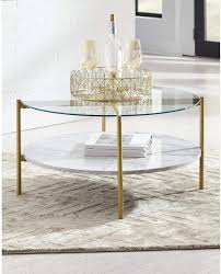 The pierre coffee table is a modern fractured gold leaf cocktail table made of gold leaf over iron with carrara marble and bevelled edge glass. Amazon Com Signature Design By Ashley Wynora Contemporary Round Coffee Table With Glass Faux Marble White Gold Furniture Decor