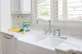 This satin white farmhouse sink base cabinet offers the ability to cut out for multiple options. Off White Kitchen Cabinets With Dual Farm Sink Transitional Kitchen