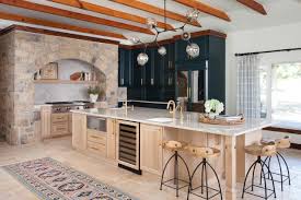 This open concept kitchen features high storage cabinets up to the ceiling. Kitchen Ceiling Ideas
