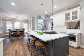 This traditional neutral toned kitchen features a harmonious color scheme of light wood cabinets for storage and neutral tile floors. Wood Look Tile Flooring Design Ideas Designing Idea