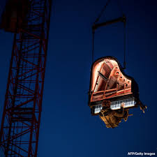 ABC News - Swiss pianist Alain Roche performs suspended in... | Facebook