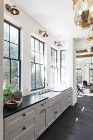 Find a comfy and quiet spot and get ready to feel completely inspired by this beautiful kitchen project. White Kitchen Cabinets With Black And Gold Hardware Transitional Kitchen