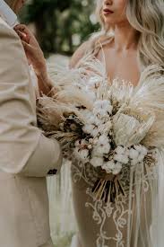 The loose, organic feel using wildflowers and traditional blooms such as spray roses and scabiosa pods blend together creating boho heaven. This Beachy Boho Wedding At Sanctuary Ho Tram Is Like A Royal Mermaid Affair Junebug Weddings Monochromatic Wedding Lilac Wedding Bouquet Monochromatic Wedding Colors