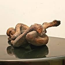 Sold. Thanks! Dynamic figure study by Chicago Artist Joyce Marcus. The  figure is nicely executed in terra cotta with a mottled dark glaze. The  ceramic sculpture measures 12" and is initialed and