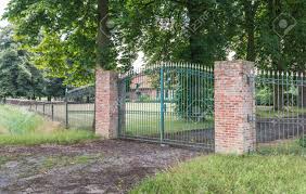 The iron pillar of delhi is a structure 23 feet 8 inches (7.2 metres) high with 16 inches (40.64 cm) diameter that was constructed by chandragupta ii (reigned c. Green Wrought Iron Gate And Two Masonry Brick Pillars Before Stock Photo Picture And Royalty Free Image Image 21673729