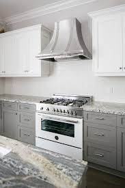 I think it brings a more modern look to a traditional design. Steel French Range Hood With White And Gray Cabinets Transitional Kitchen