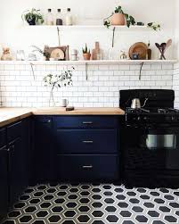 Black And White Kitchen With Wood Countertops Dark Blue And White Kitchen With Natural Wood Countertops Kitchen Flooring Kitchen Trends Kitchen Interior